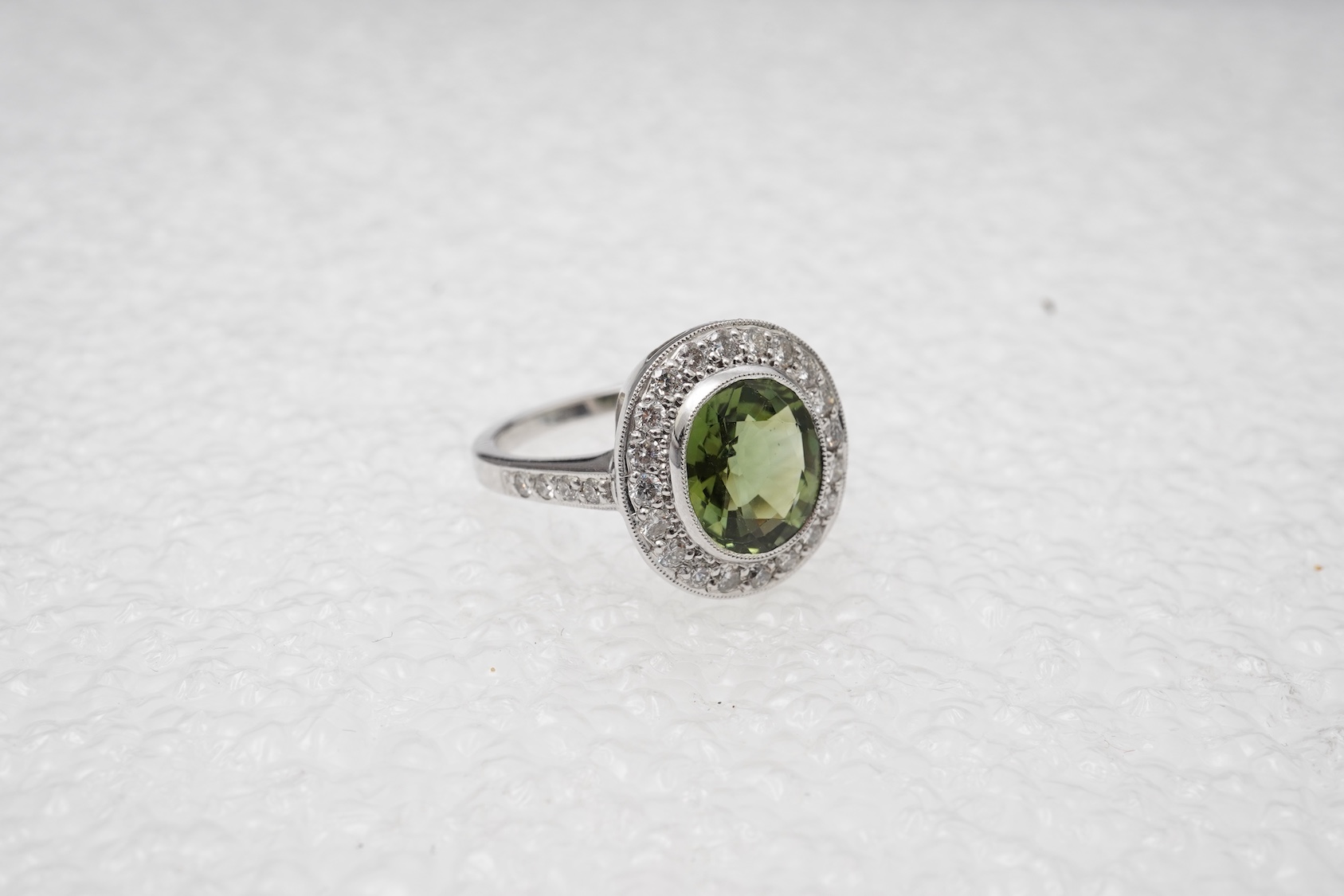 A green tourmaline and diamond cluster ring